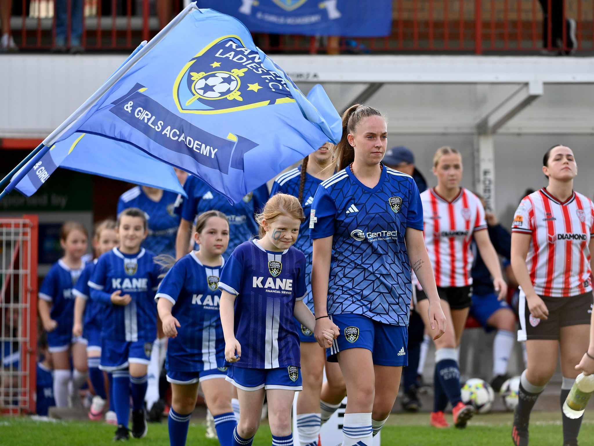 Lisburn Rangers Ladies walking onto the pitch with young mascots